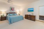 The master bedroom features a king size bed, end tables with lamps, flatscreen TV, a large closet, fan, AC and a small lanai